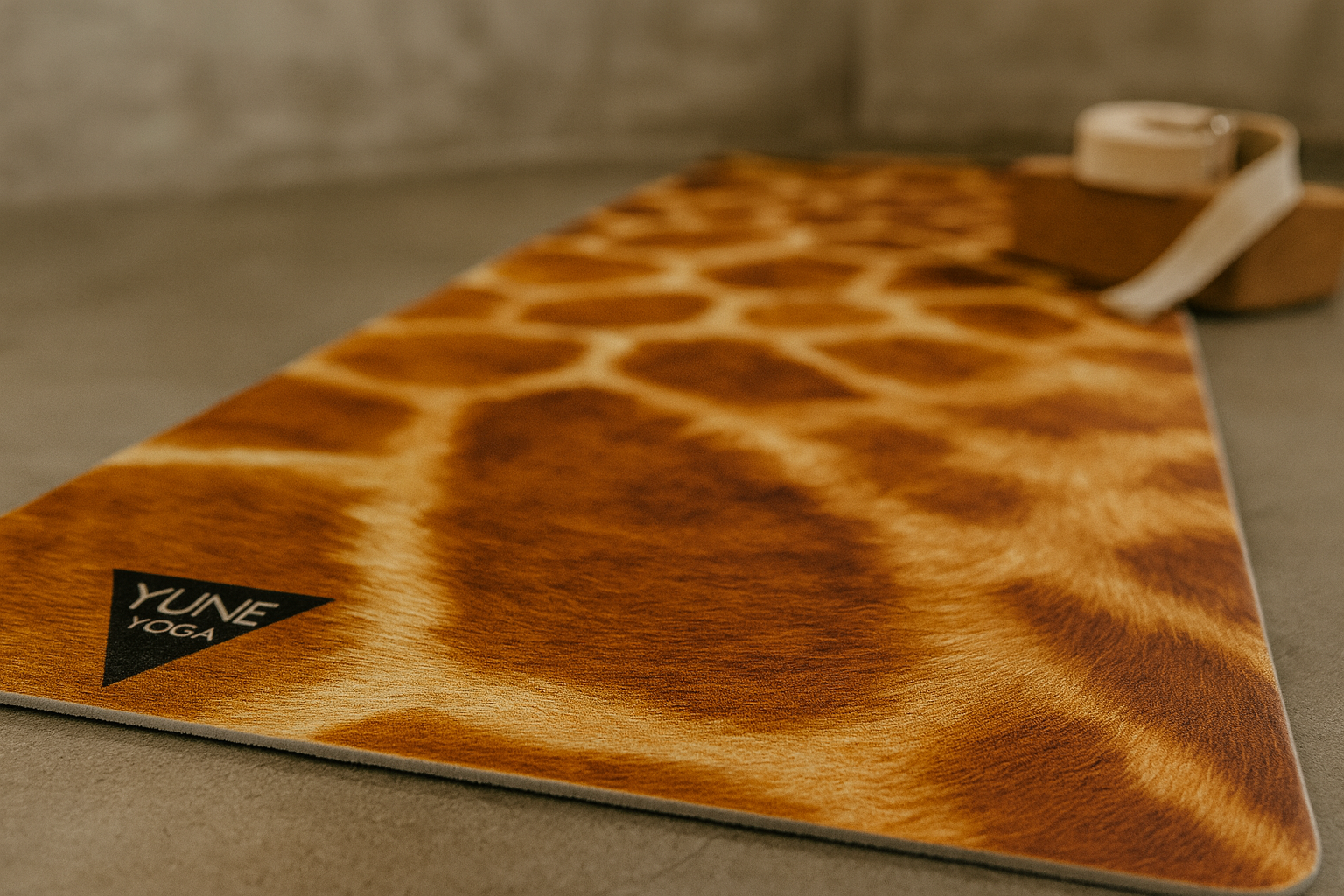 Brown leather mat with a pattern and 'Yume' brand logo on a gray surface.