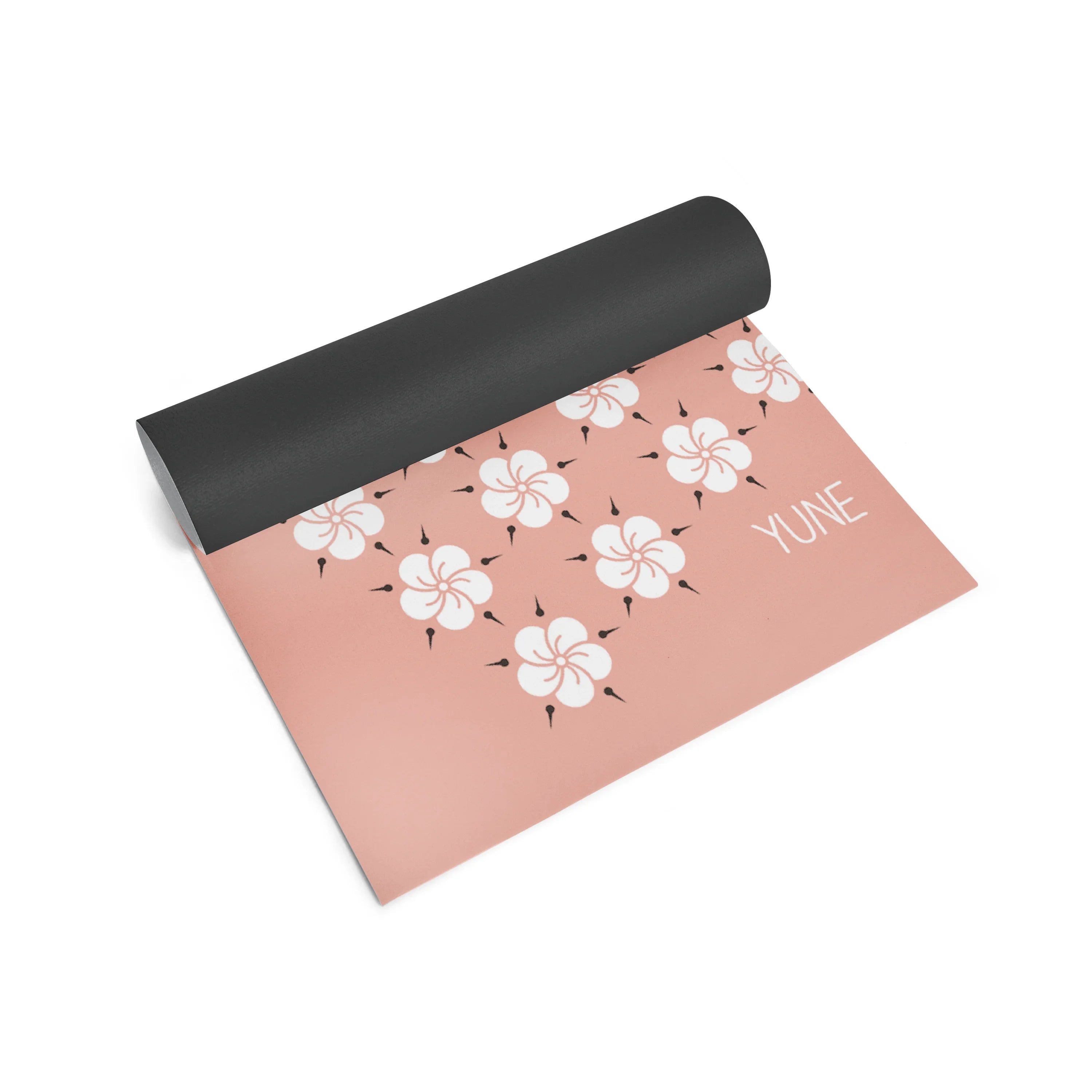 Yoga mat with floral pattern and 'YUNE' branding on a white background