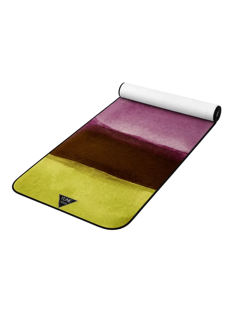Watercolor yoga mat with green, brown, and purple gradient on white background