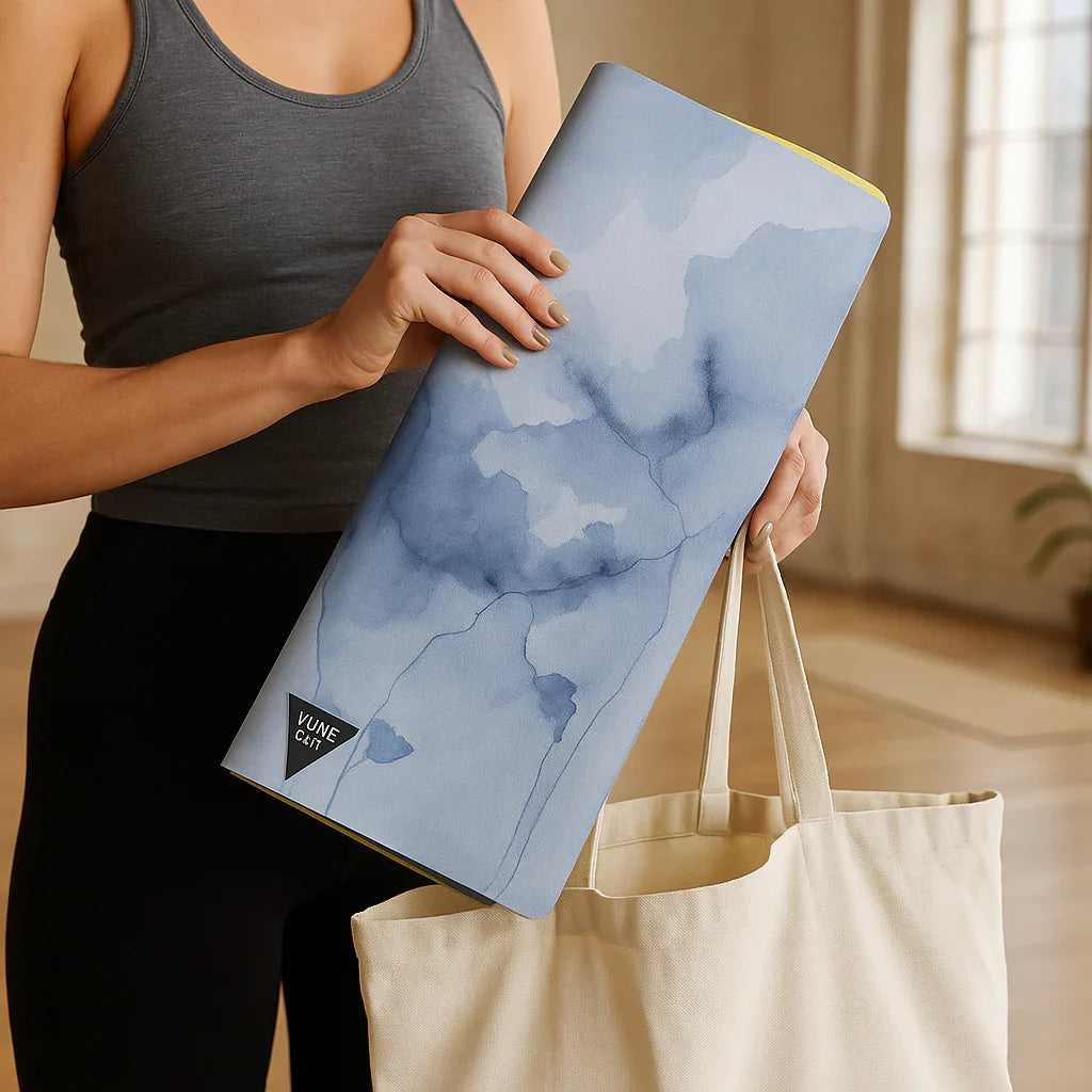 Person holding a blue watercolor laptop case with 'Vum' branding.