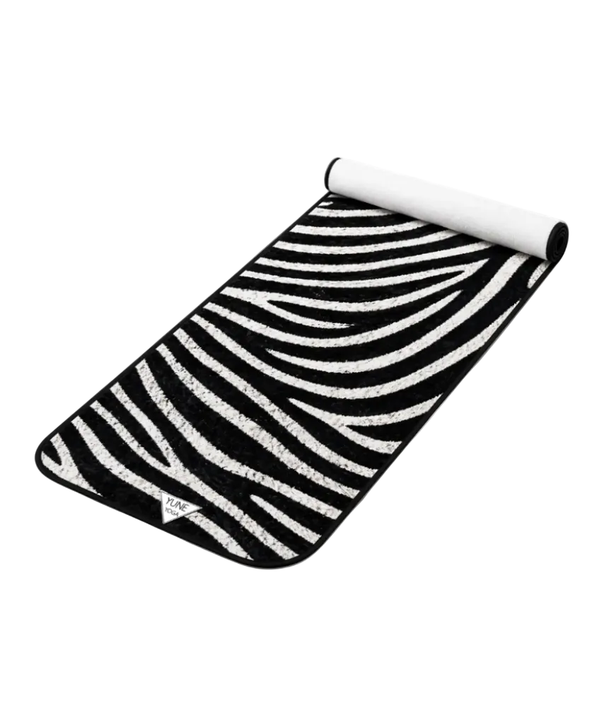 Roll-up black and white striped mat on a white background