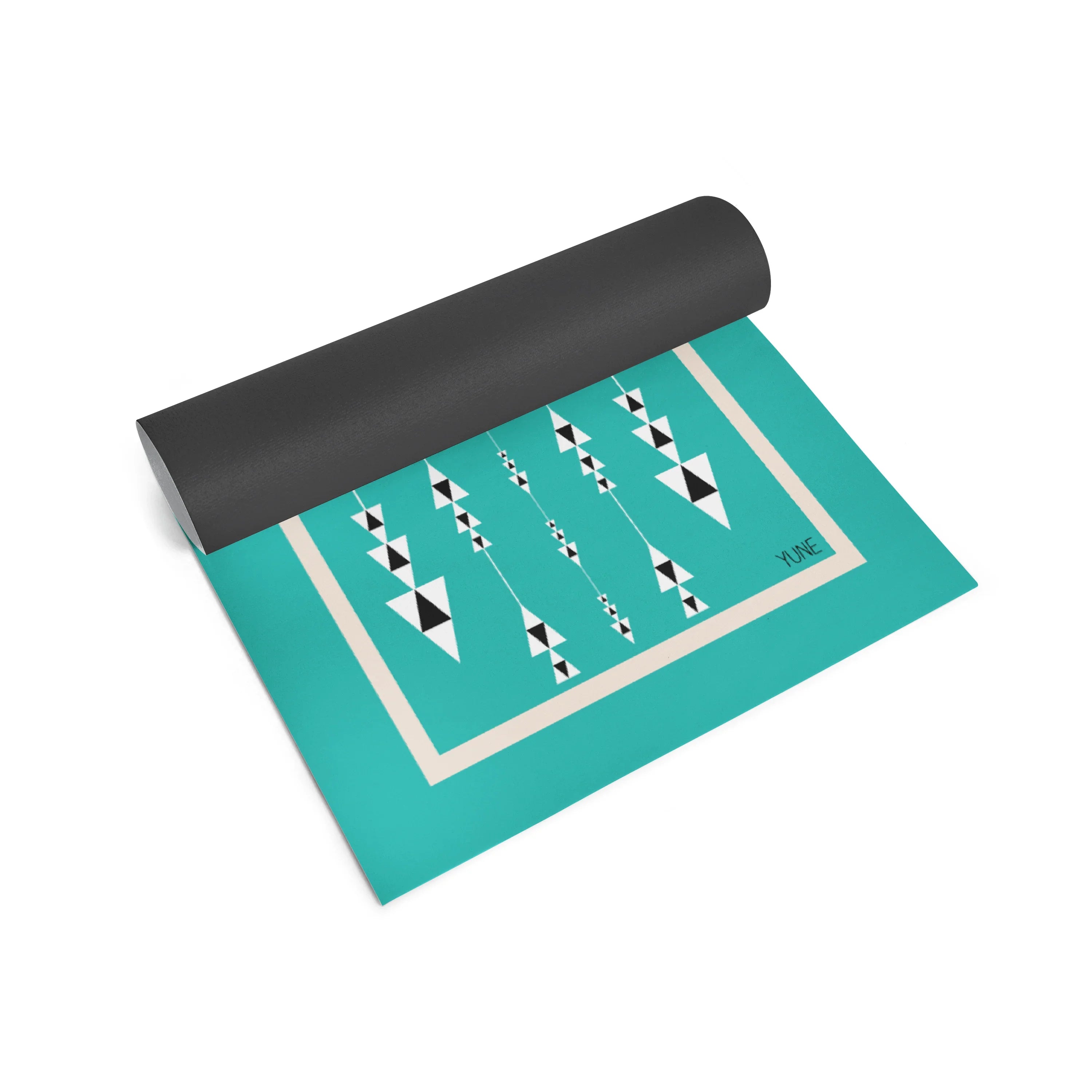 Teal yoga mat with black and white geometric pattern on a white background