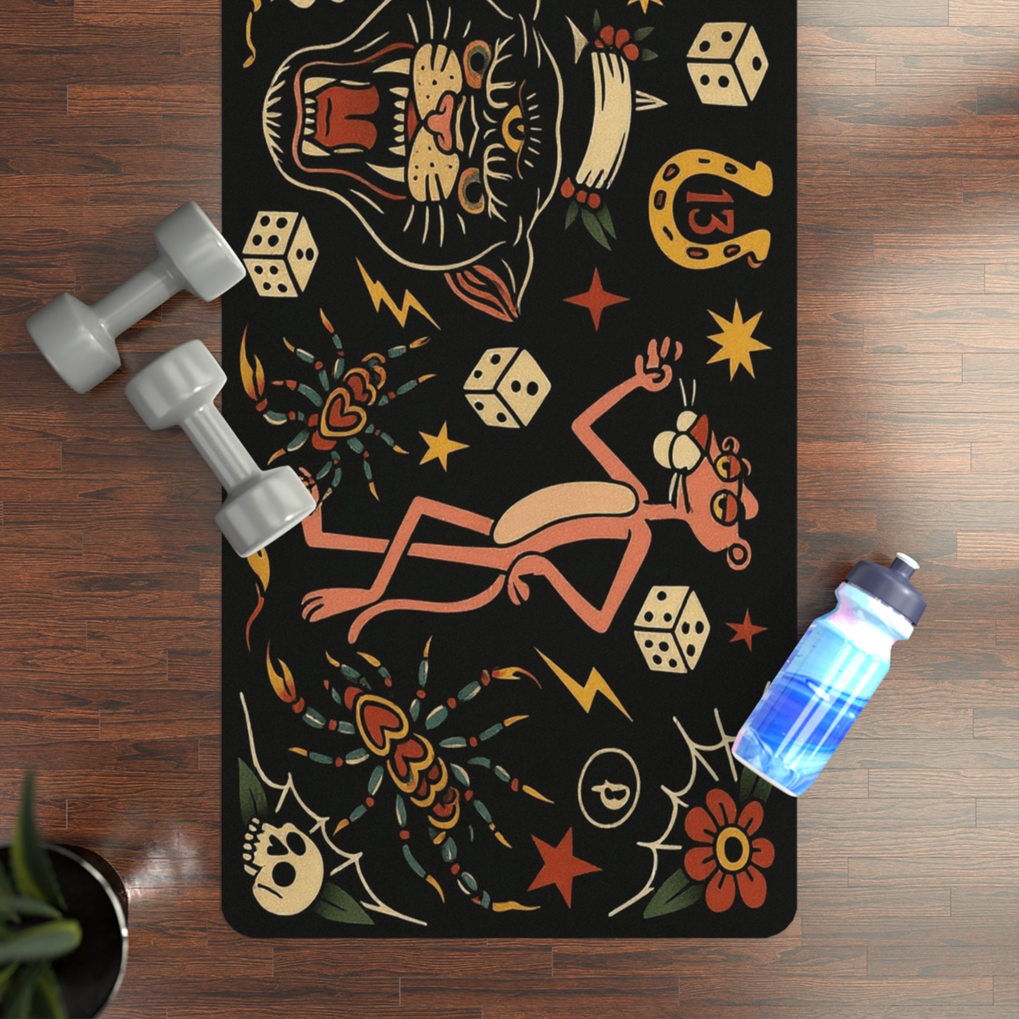 Yoga mat with colorful designs on a wooden floor with dumbbells and a water bottle.