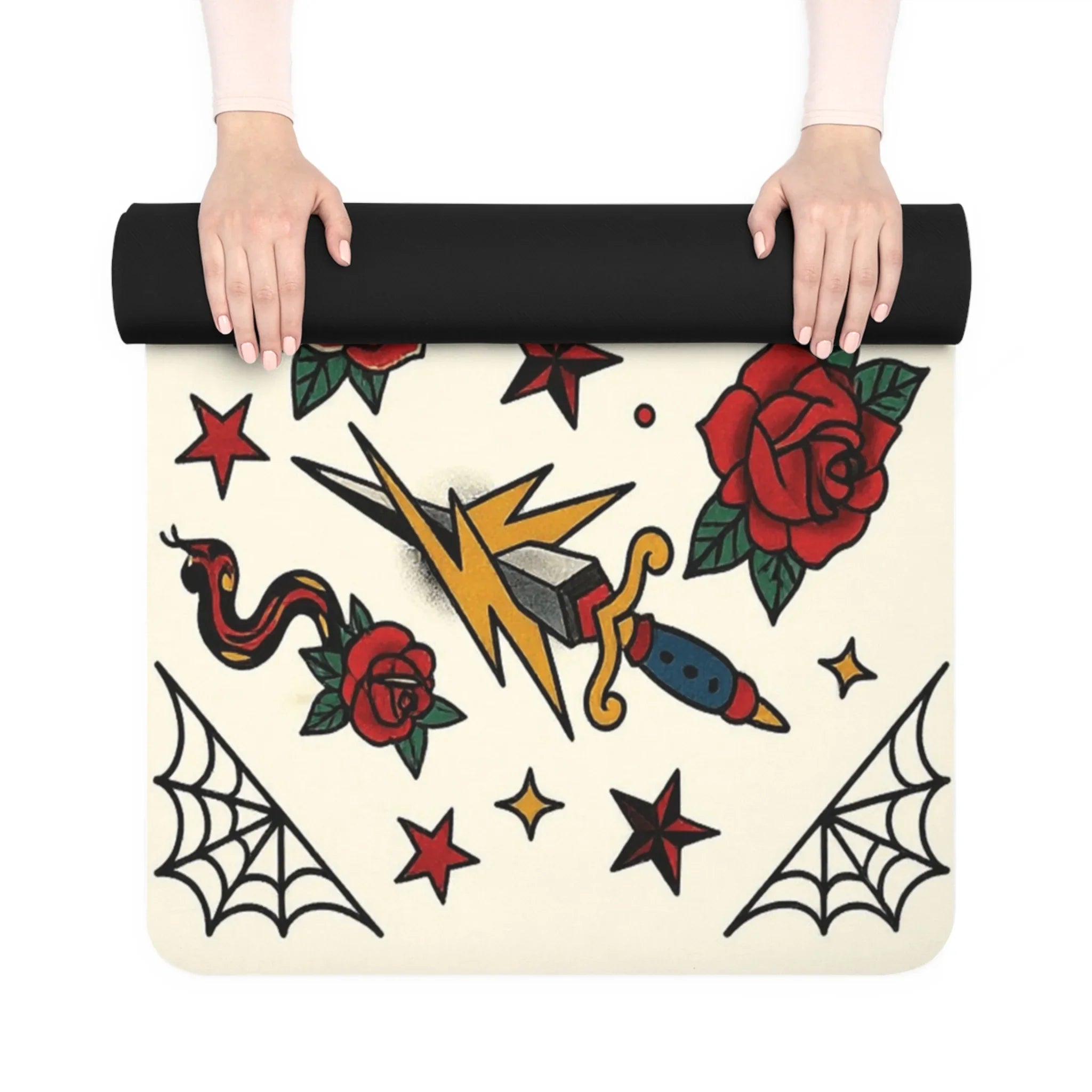 Yoga mat with tattoo-style designs held by hands on a white background