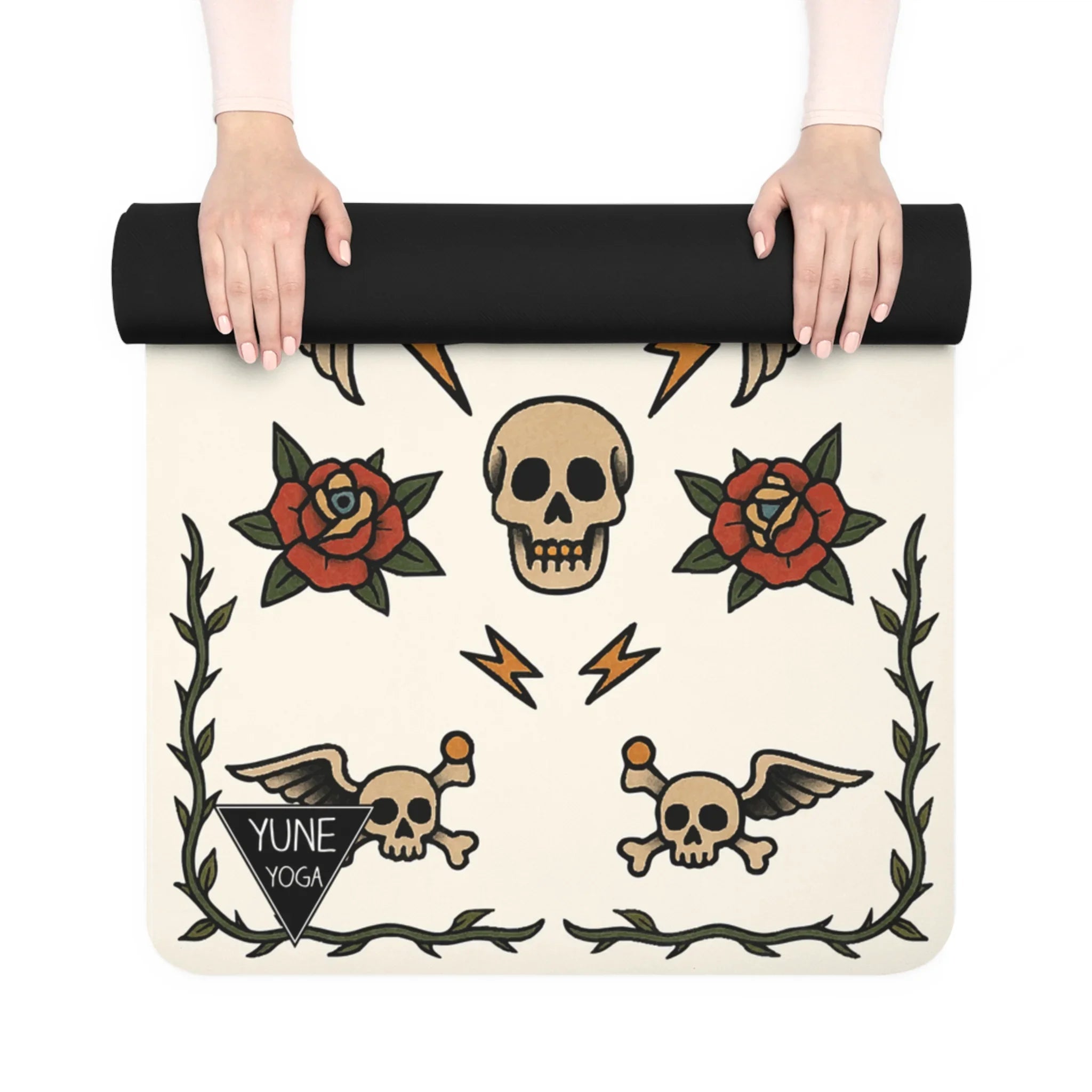 Yoga mat with skull and rose design held by a person